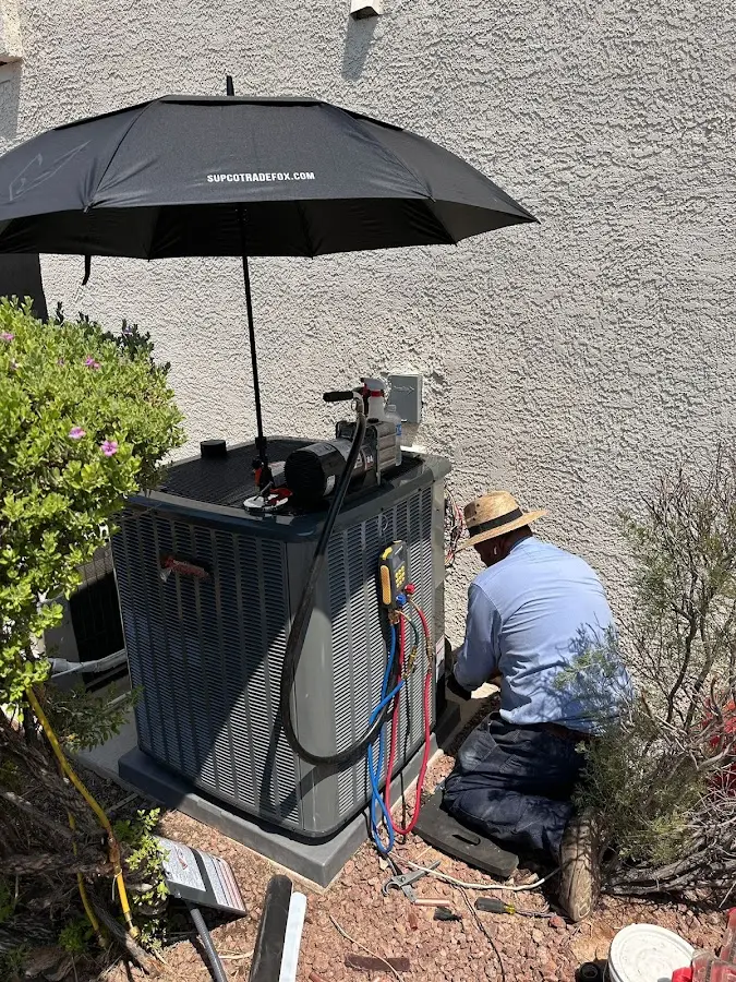 HVAC technician performing outdoor AC maintenance in Jensen Beach